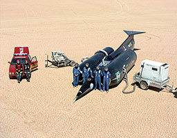 The start team pose with their equipment and ThrustSSC - the Palouste is the white box on the right