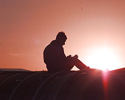 Andy Green astride ThrustSSC writes up his notes as the car is towed home at sunset