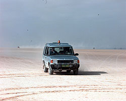 A Land-Rover Discovery returns to the desert pits after checking the water's progress