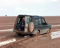 Brian Palmer pulls in the winch cable for towing the Discovery clear