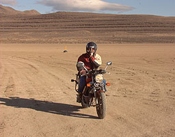 Andy Green drives up on his motorbike