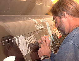Joe Broxterman signwriting the Sterling Software logo
